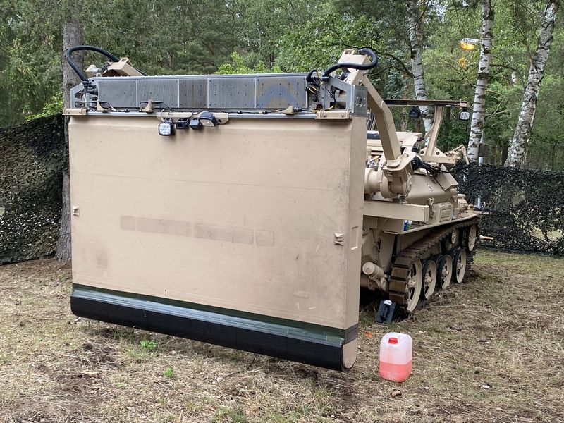 Tracked pioneer kit with a large blade in the wood