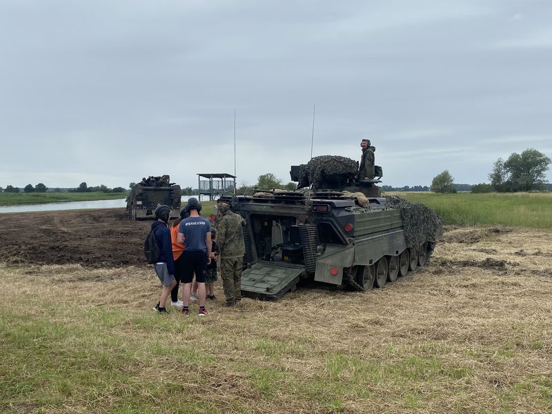 Visitors at the open rear of a tracked vehicle on the Havel bank