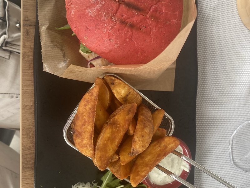 Einzelner Havelburger mit Kartoffelspalten und Dip